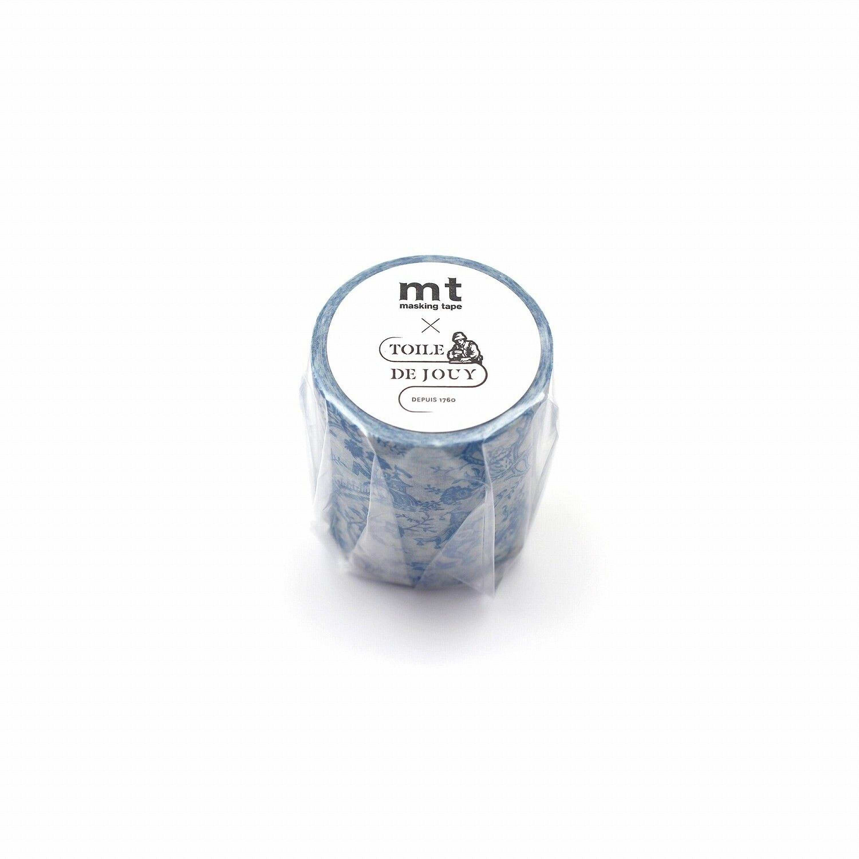 A blue and white patterned container with a label that reads "mt masking tape TOIL & DE JOUY" and "DEPUIS 1980".