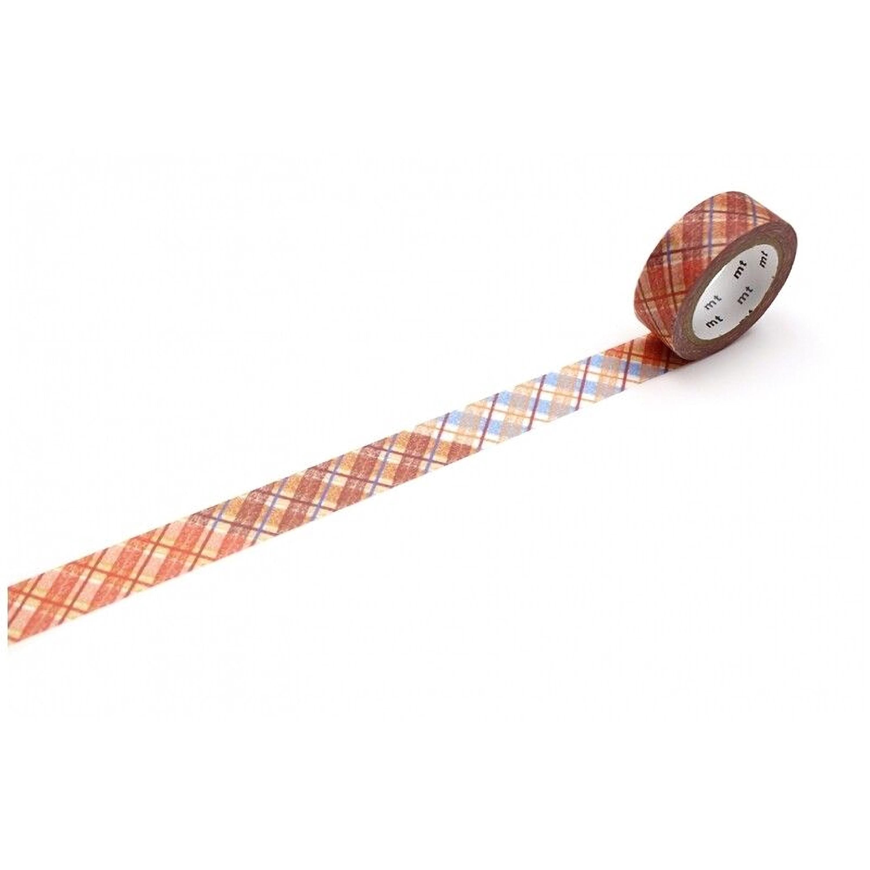 A roll of patterned tape with a plaid design is lying on a white surface.