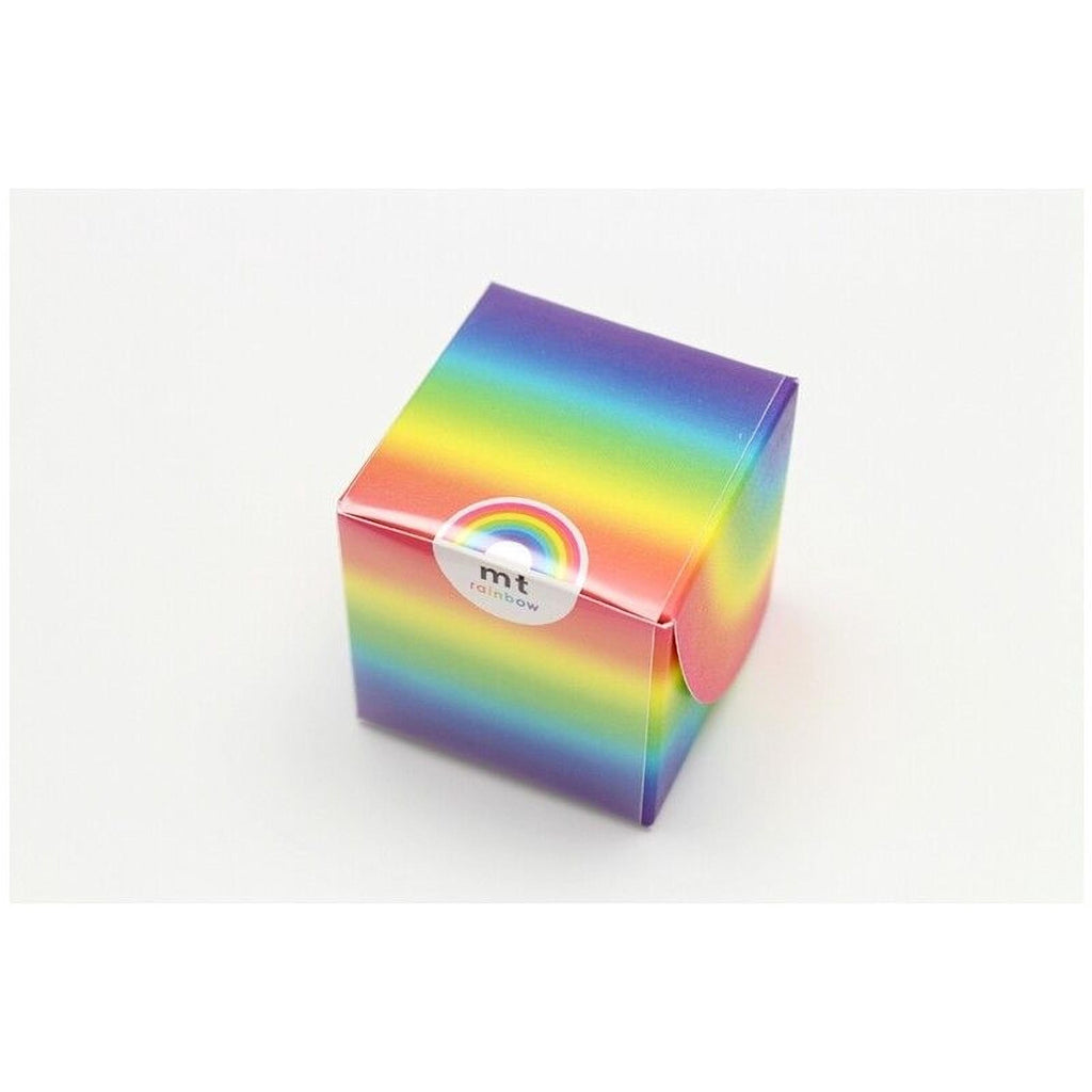 A colorful, rainbow-colored box with a white label on it.