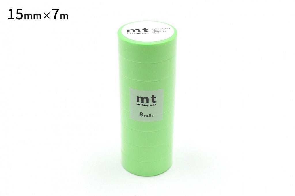 A stack of green cylindrical objects, likely some kind of packaging or container, with a label on the top.