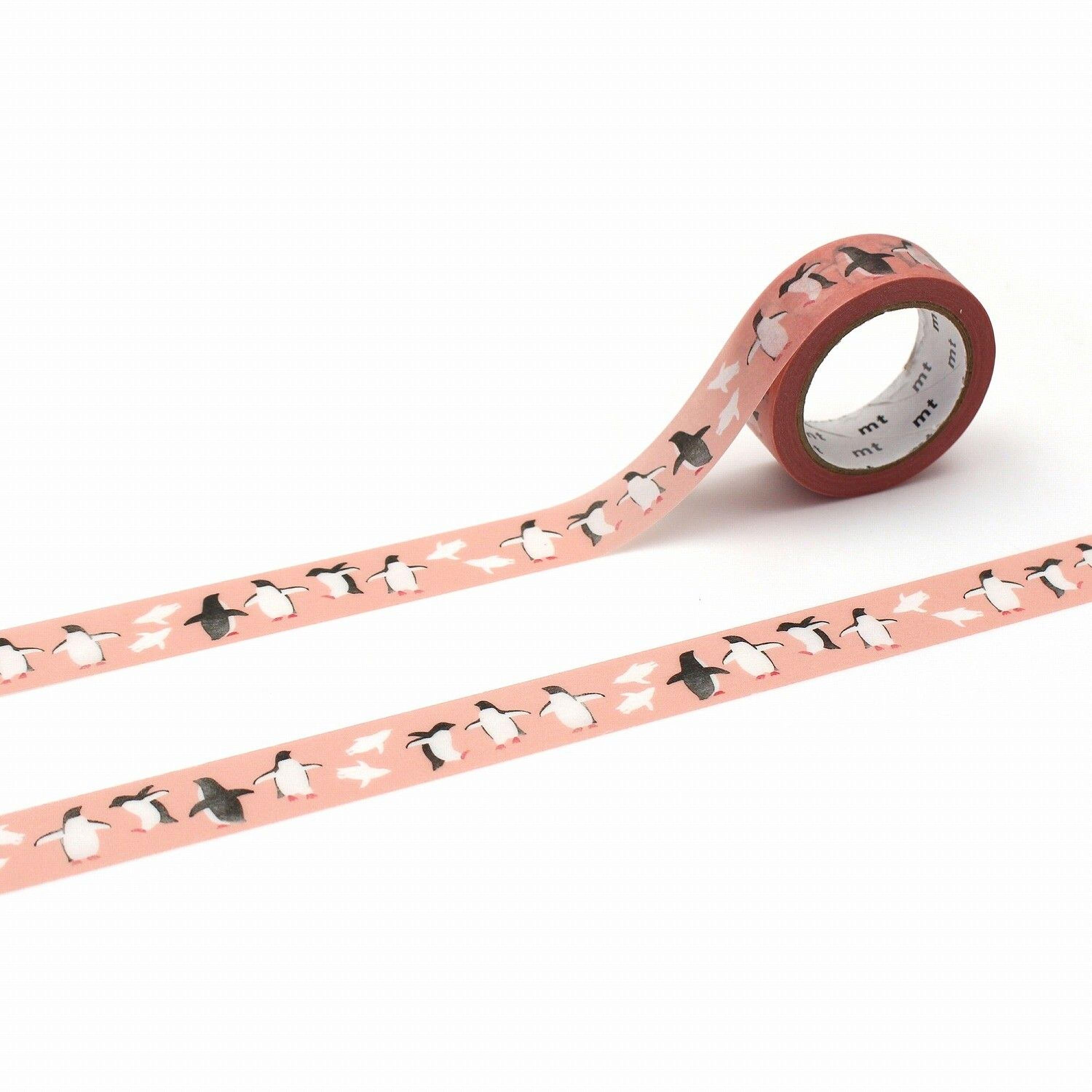 a roll of pink and white tape with a repeating pattern of penguins on it.