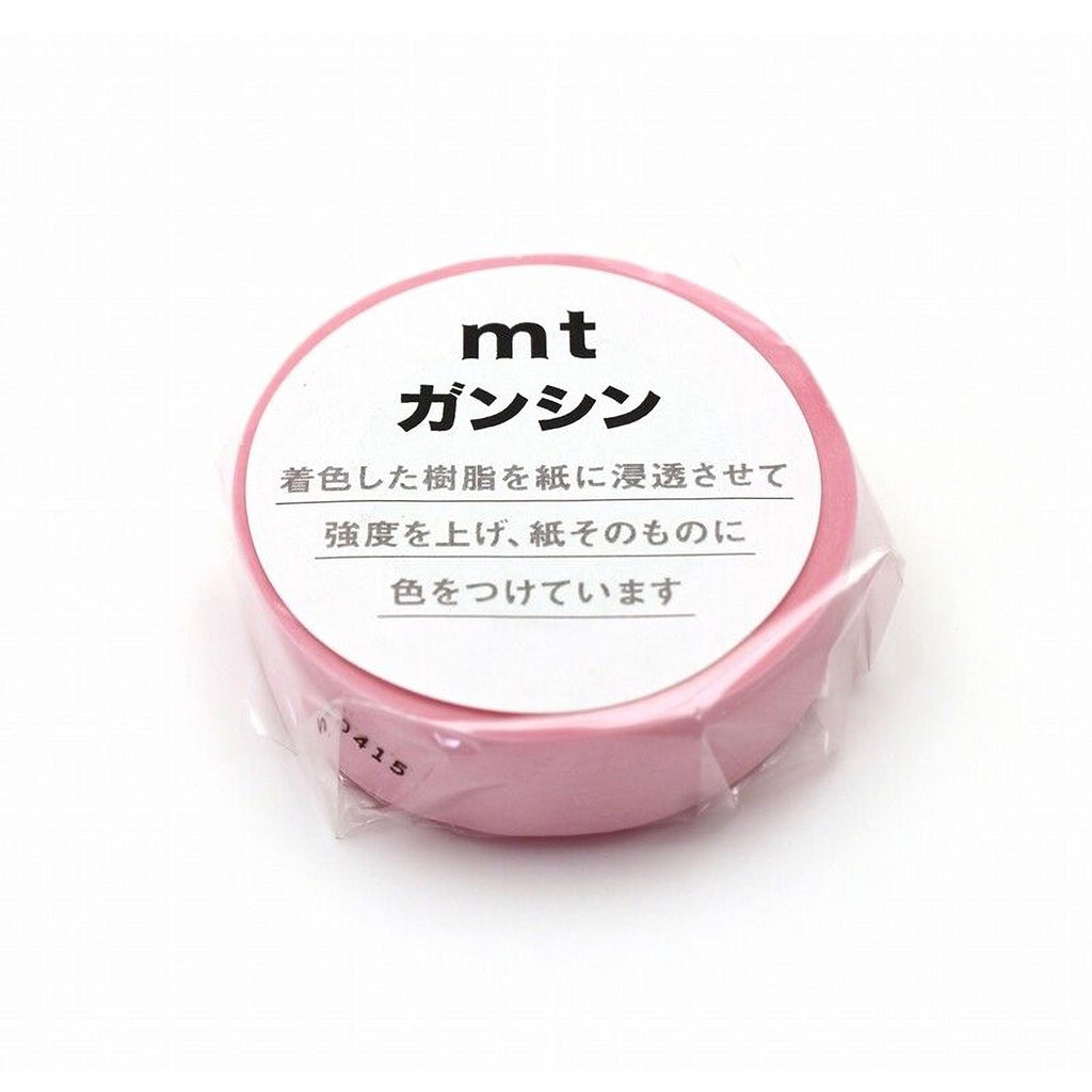A pink circular object with Japanese text on it, which appears to be a product or packaging.