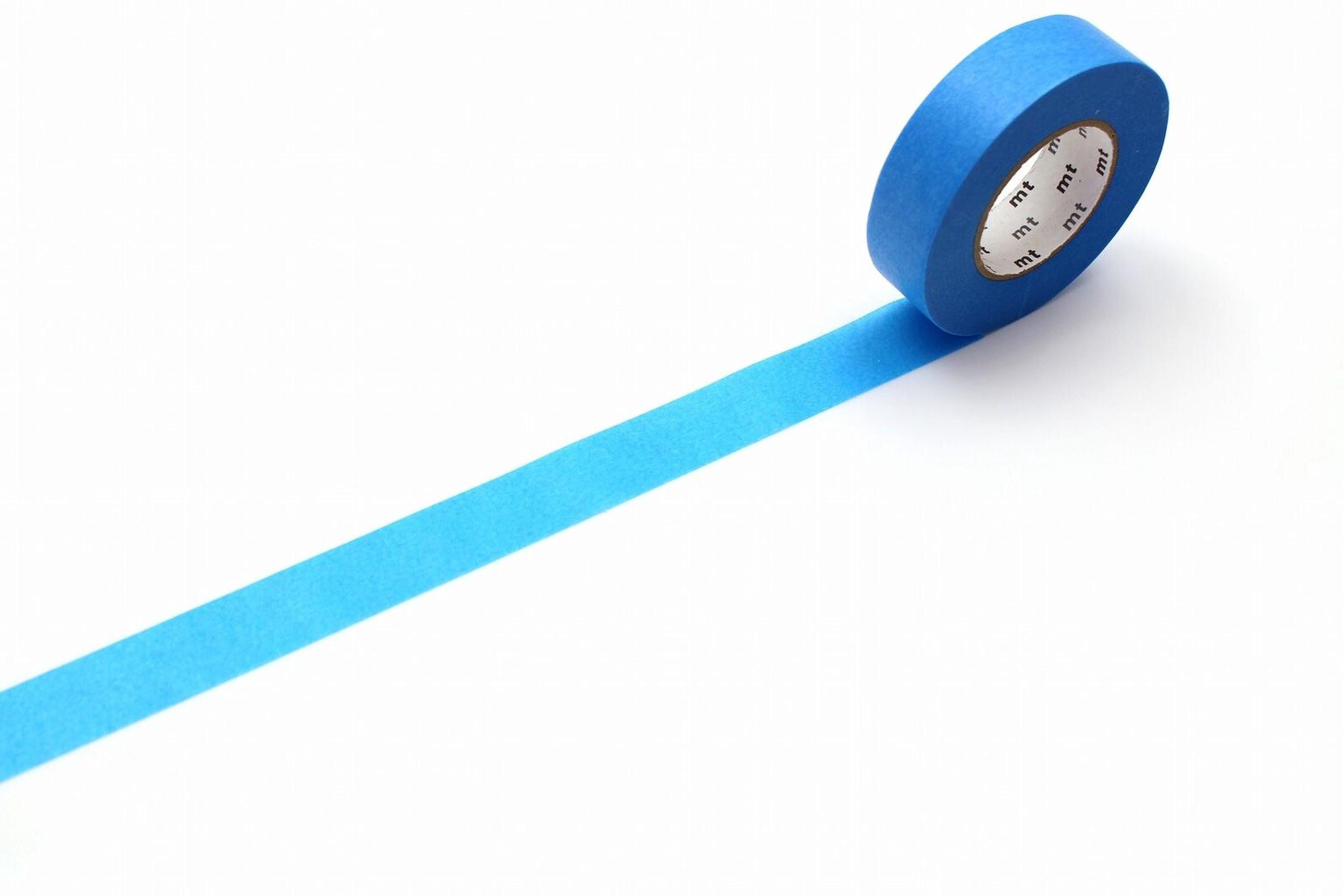 A roll of blue painter's tape is lying on a white surface, with a blue line extending from the tape.