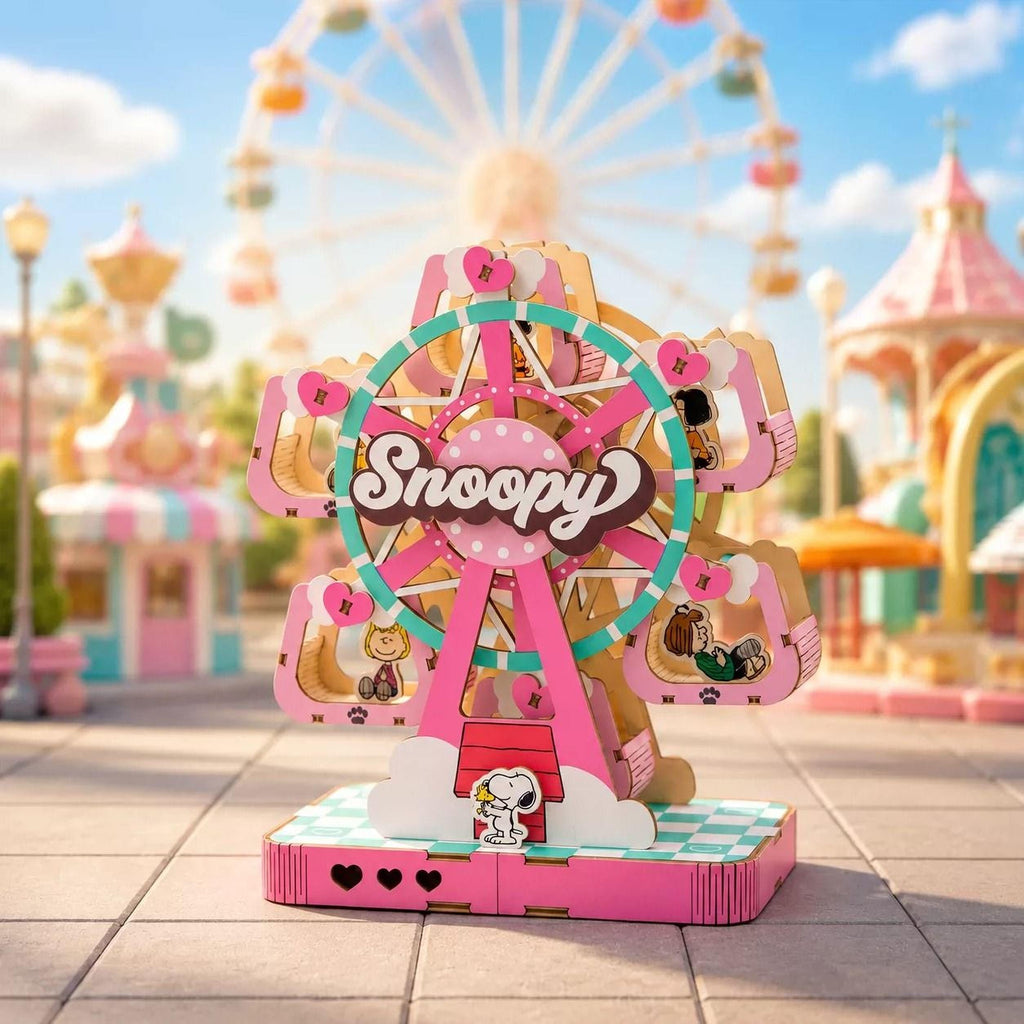 A colorful and whimsical miniature Ferris wheel with the word "Snoopy" prominently displayed, set against a backdrop of a lively amusement park scene.
