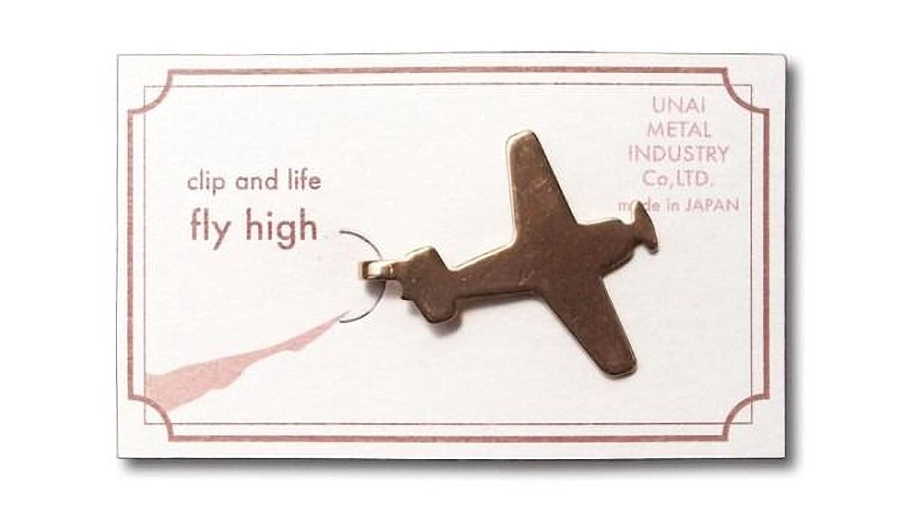 a small airplane-shaped clip or pin, which is a decorative item.