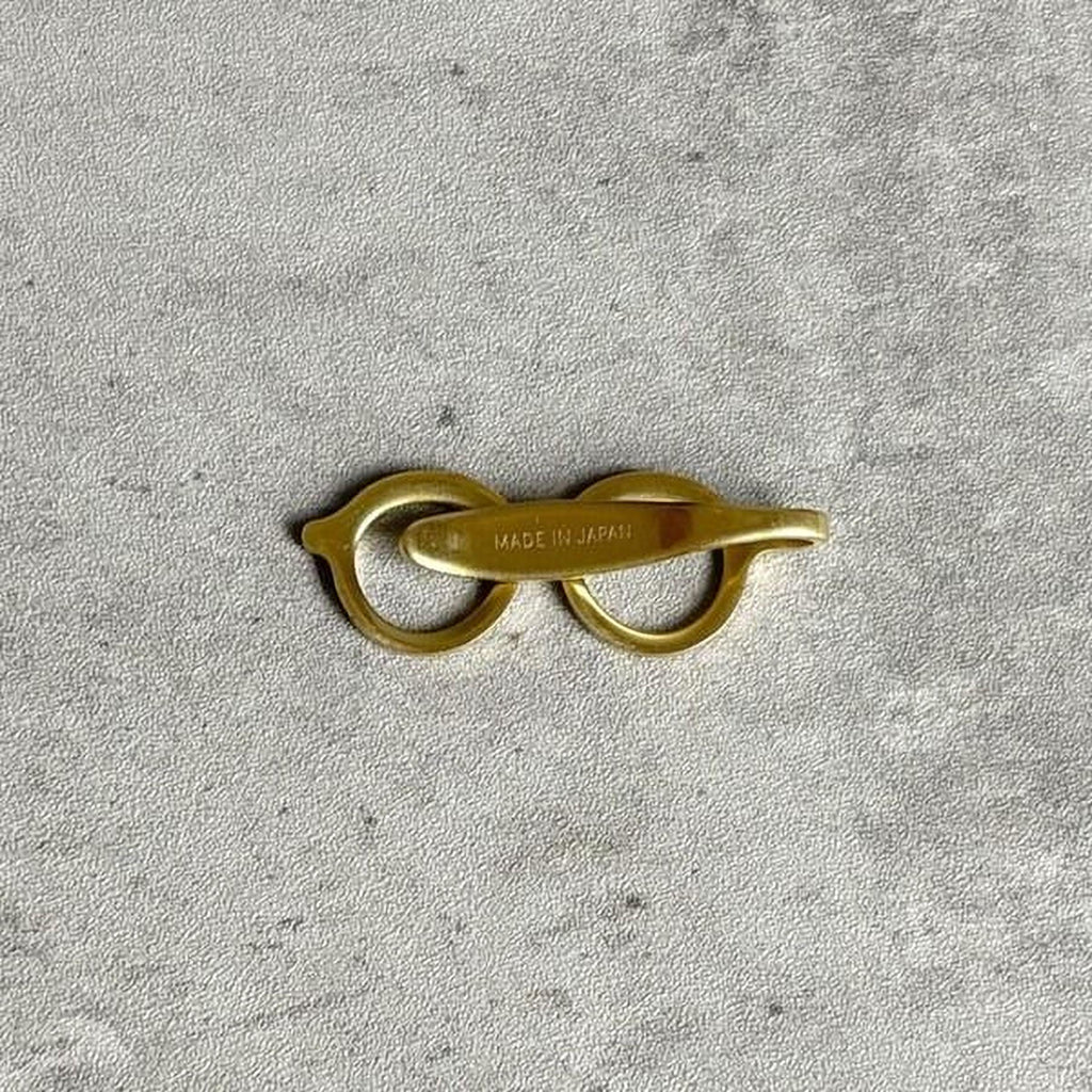 A pair of gold-colored metal scissors with the text "MADE IN JAPAN" printed on them.