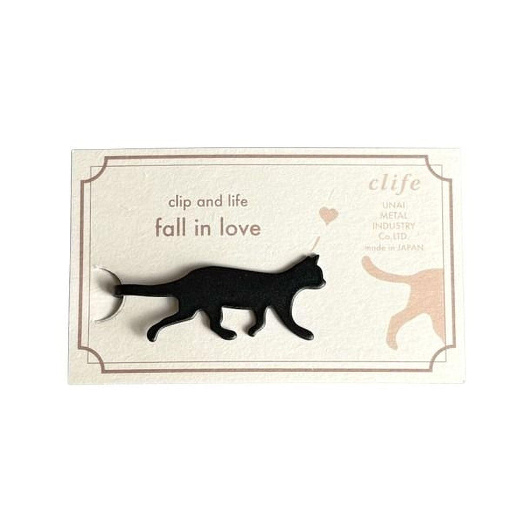 a black cat walking on a white background.