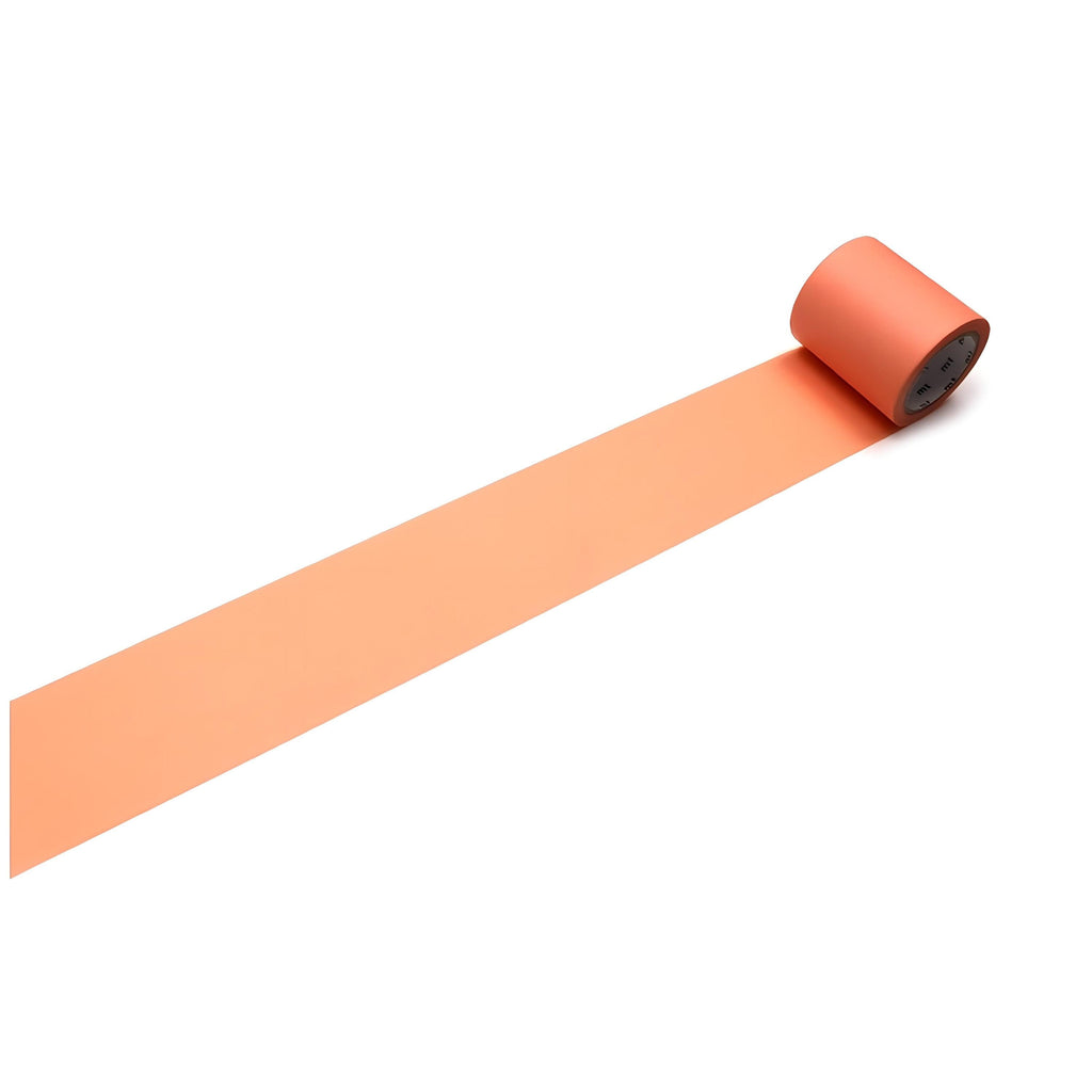 A roll of orange tape is lying on its side on a white background.