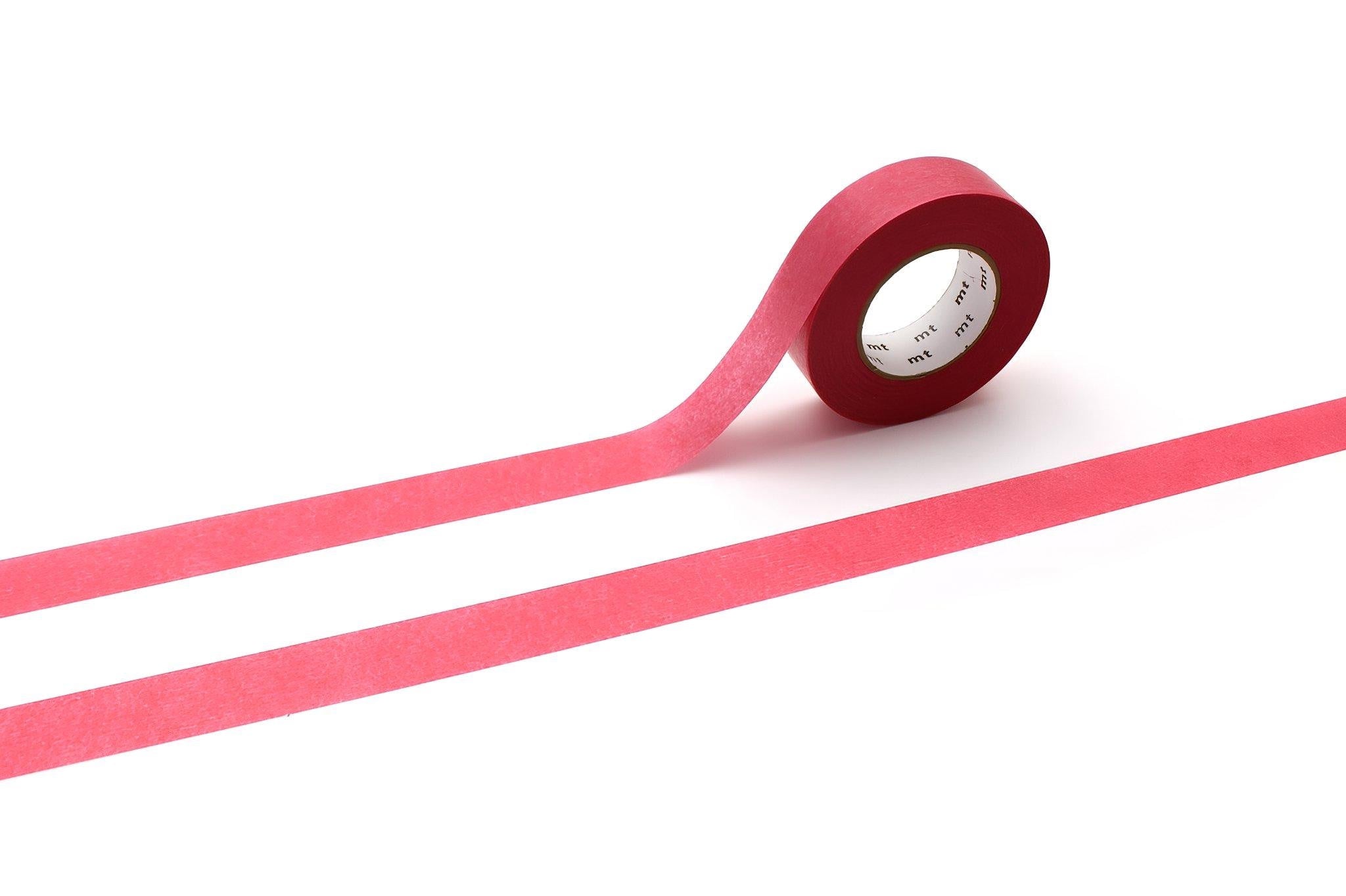 A roll of red masking tape is lying on its side on a white background, with a horizontal red line extending from the tape.