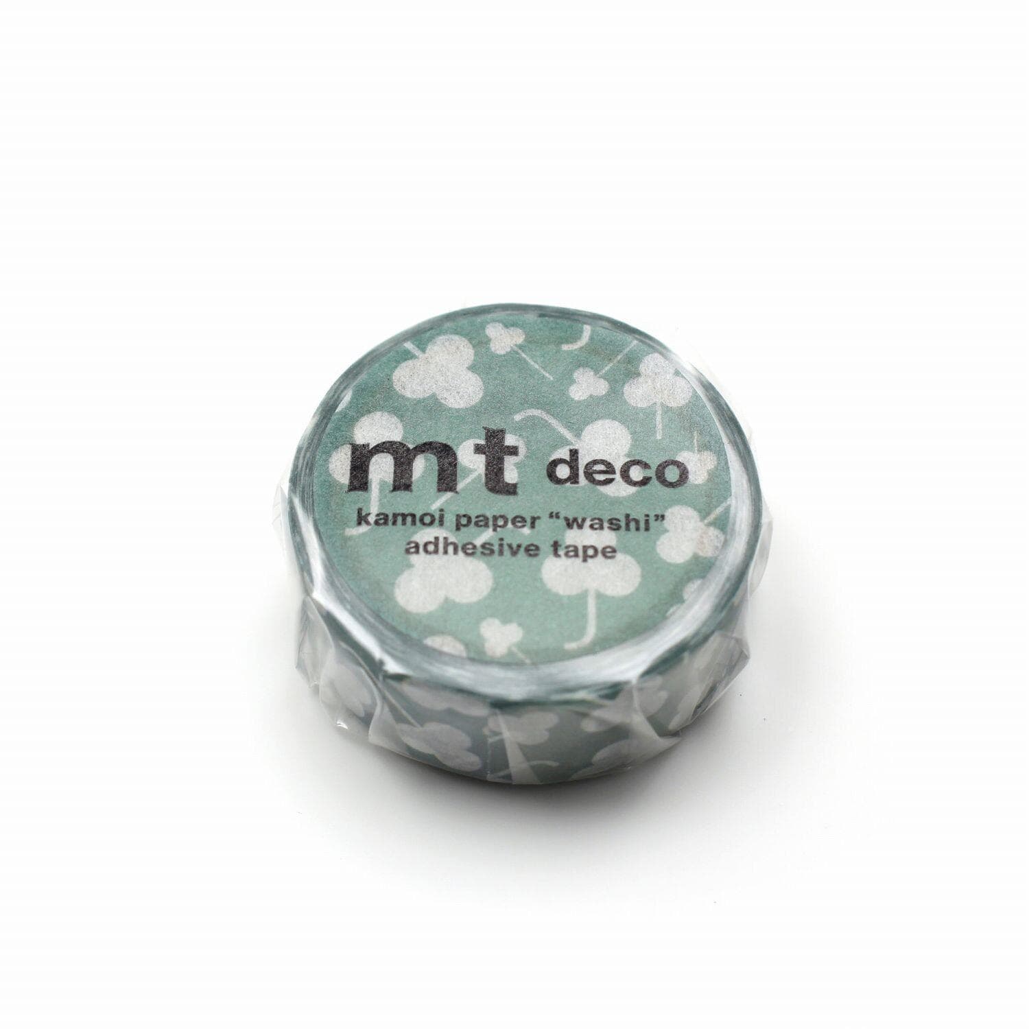 A round, green-colored roll of kamor paper "washi" adhesive tape with a white floral pattern.