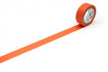a roll of orange tape with a clock face on it, placed on a white surface.