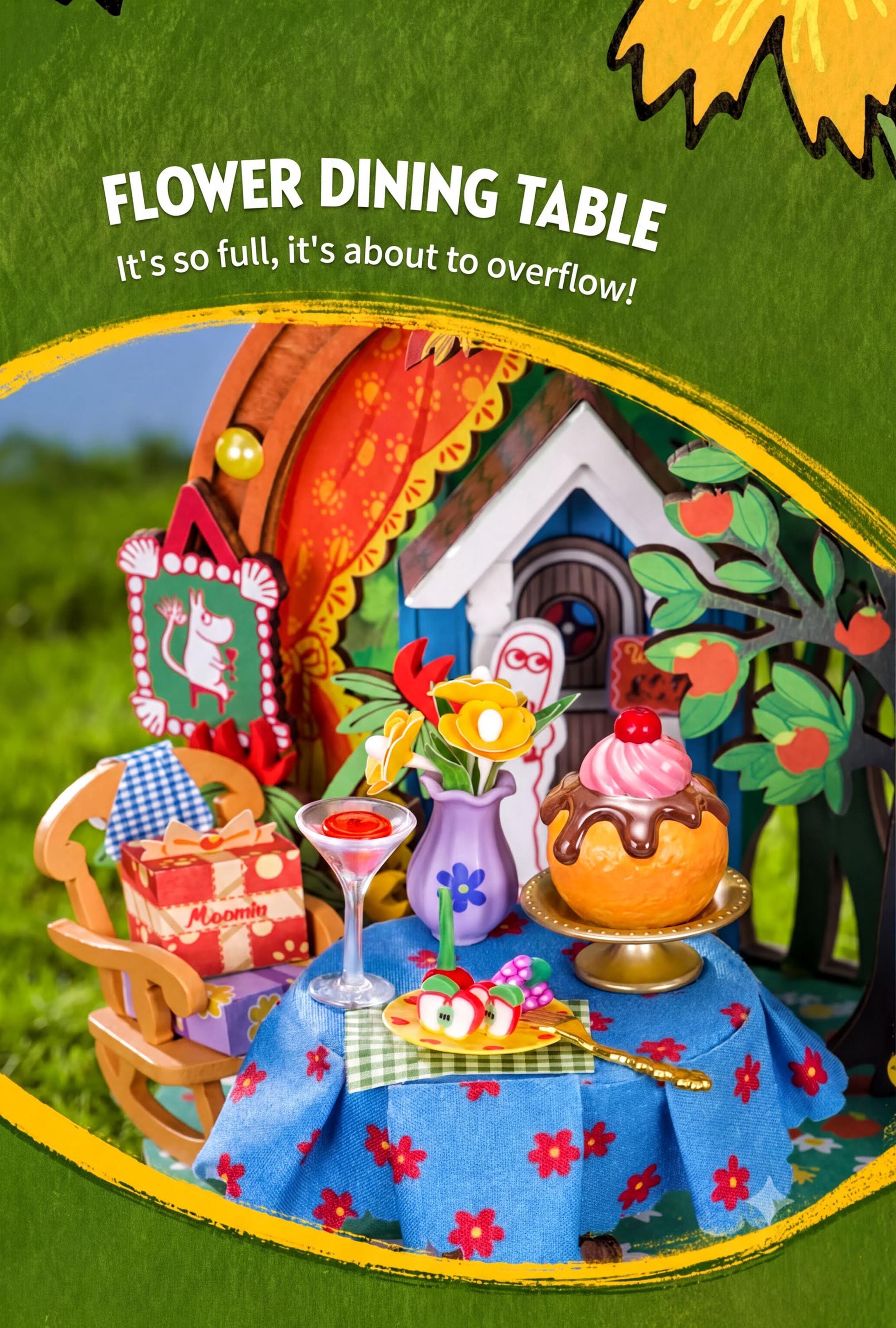 The image is a colorful and whimsical miniature diorama depicting a flower dining table with various decorative elements, including a vase, flowers, and a cake.