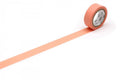 a roll of orange-colored tape with a white pattern on it, placed on a white surface.