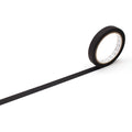 A roll of black tape with a white center is shown against a white background.
