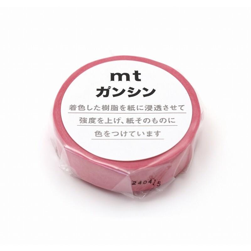 A pink circular object with Japanese text on it, sitting on a white background.
