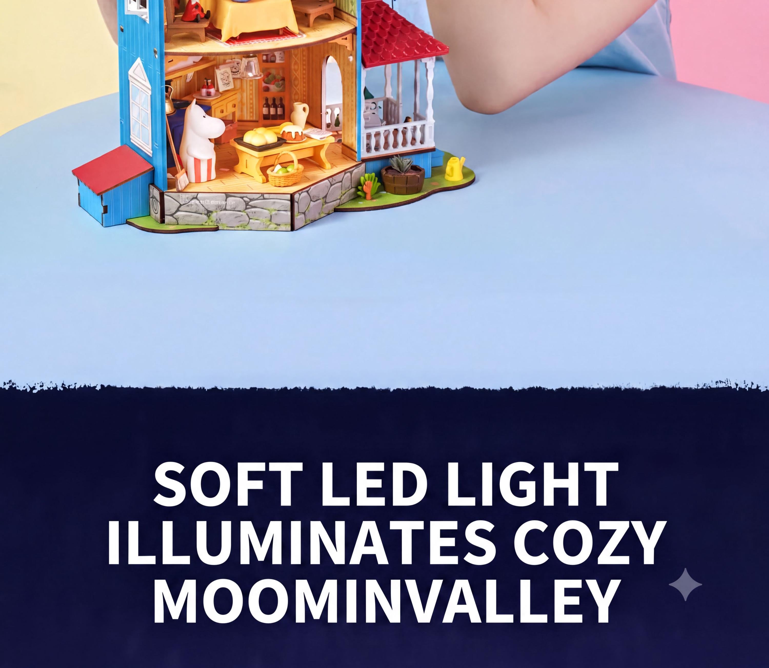 a small, colorful toy house with a red roof, situated on a blue surface.