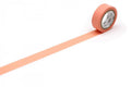 a roll of orange-colored tape with a white pattern on it, placed on a white surface.