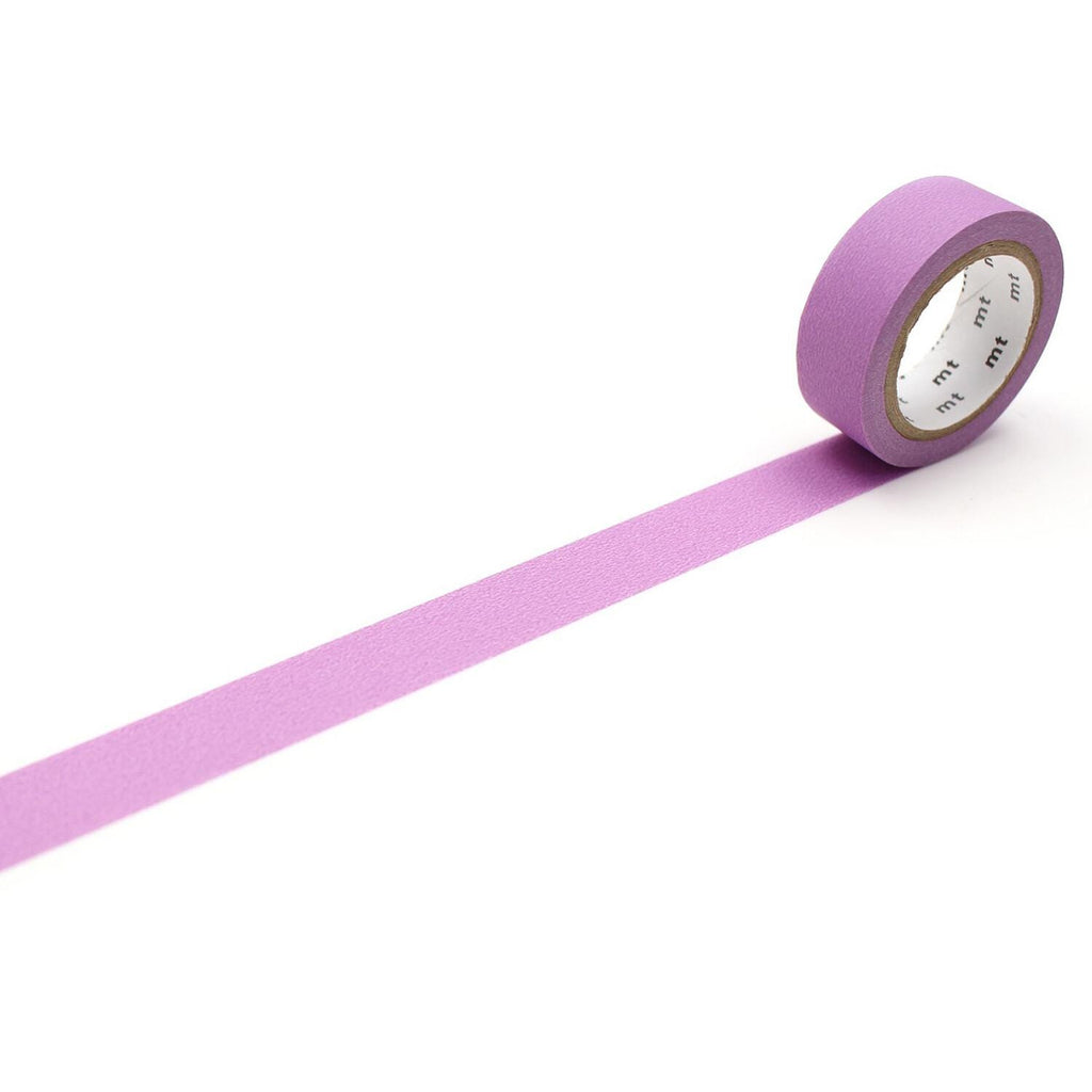 A roll of purple masking tape is lying on a white surface, with a single strip of tape extending from the end of the roll.