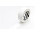 A roll of white tape with a black and white pattern on it, placed on a white surface.