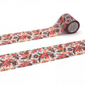 a roll of patterned tape with a floral design, lying on a white surface.