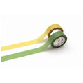 two rolls of green and yellow tape on a white background.