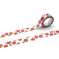 a roll of red and white patterned tape with a repeating floral design.