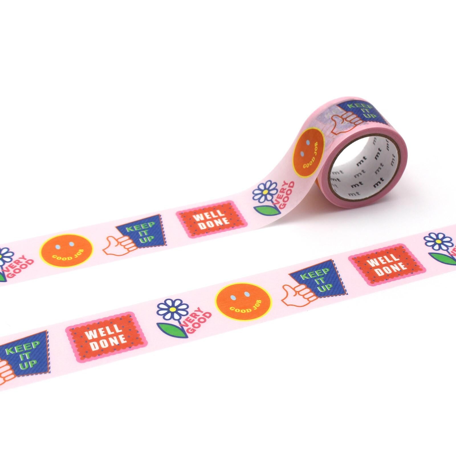 A roll of pink tape with various colorful stickers and text on it, including a smiley face, thumbs up, and the words "Well done" and "Keep it up".