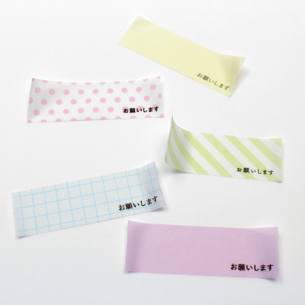 five colorful paper strips with Japanese text on them, arranged on a white background.