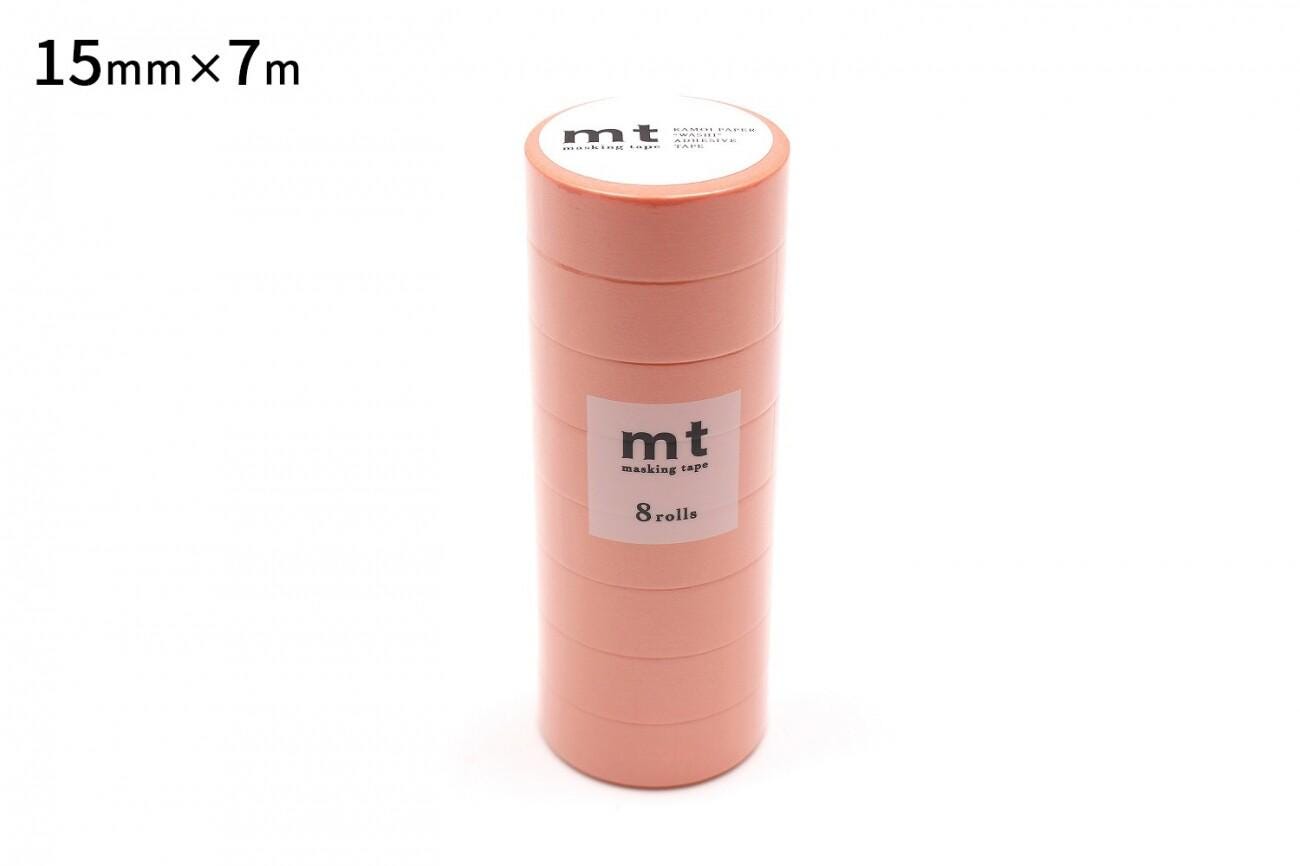 A stack of pink-colored tape rolls with the brand name "mt" printed on them.