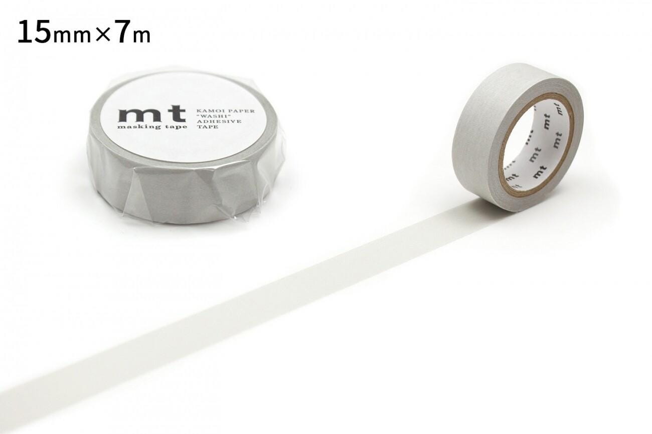 two rolls of masking tape, one with a label and the other without a label. The masking tape is white and has a label that reads "15mm x 7m".