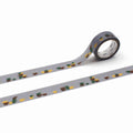 a roll of gray tape with a repeating pattern of green and brown cups on it.