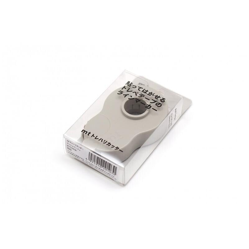 A white object with black text and a circular hole in the center, placed in a clear plastic box.