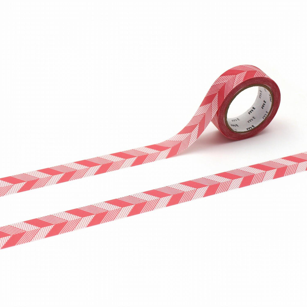 a roll of red and white checkered tape lying on a white surface.
