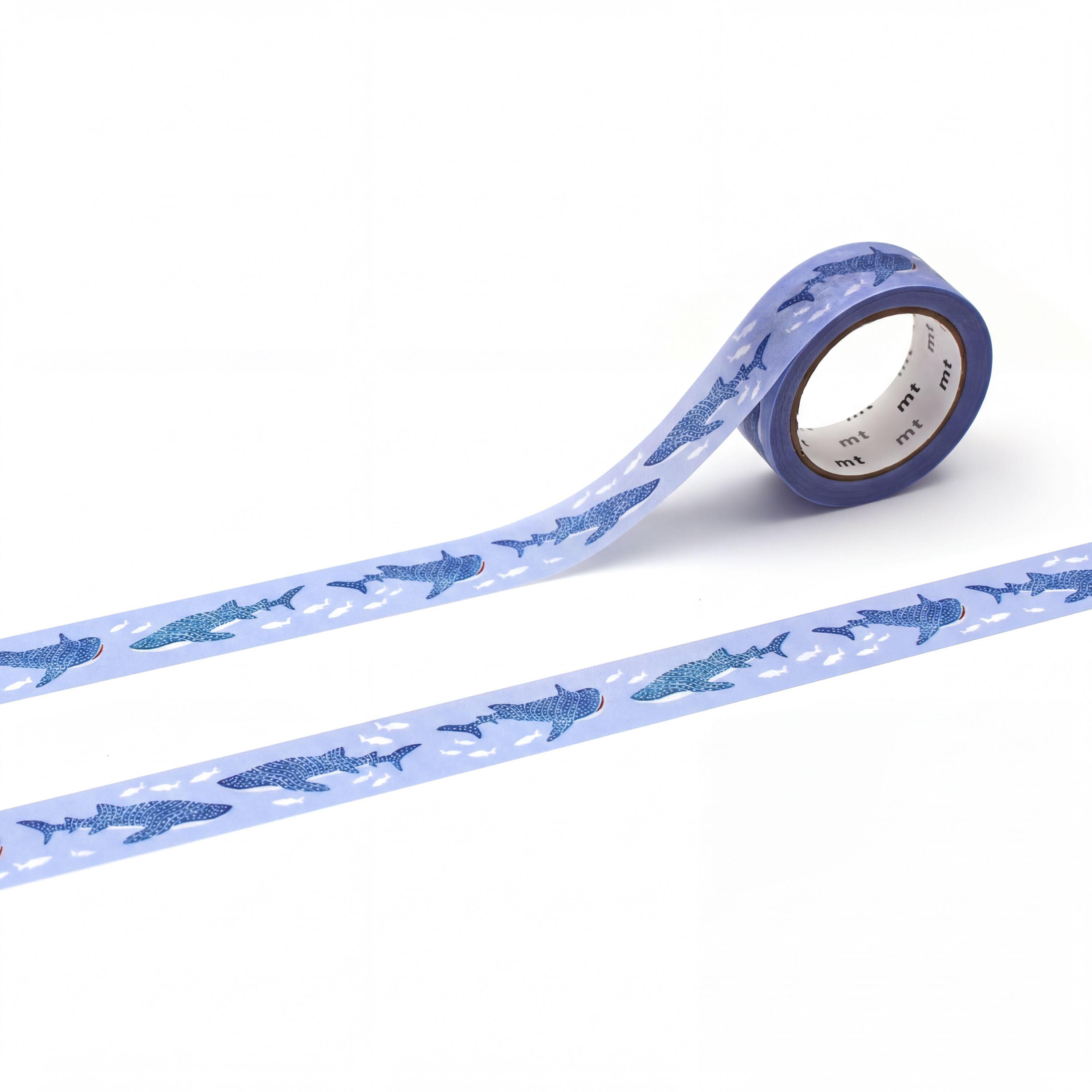 a roll of blue and white patterned tape with a repeating design of blue sharks on it.