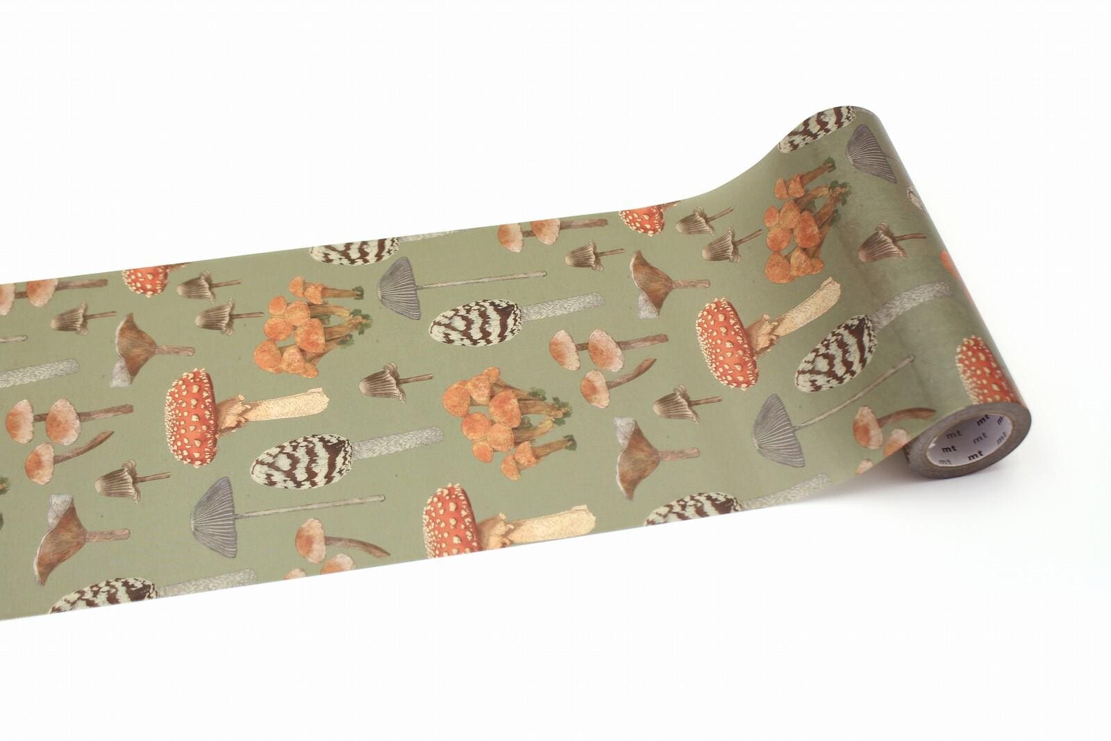 a roll of paper with a repeating pattern of various mushrooms and other organic shapes in shades of green and brown.