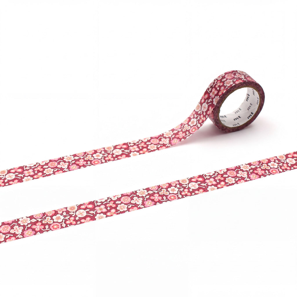 a roll of red and white floral patterned tape on a white background.